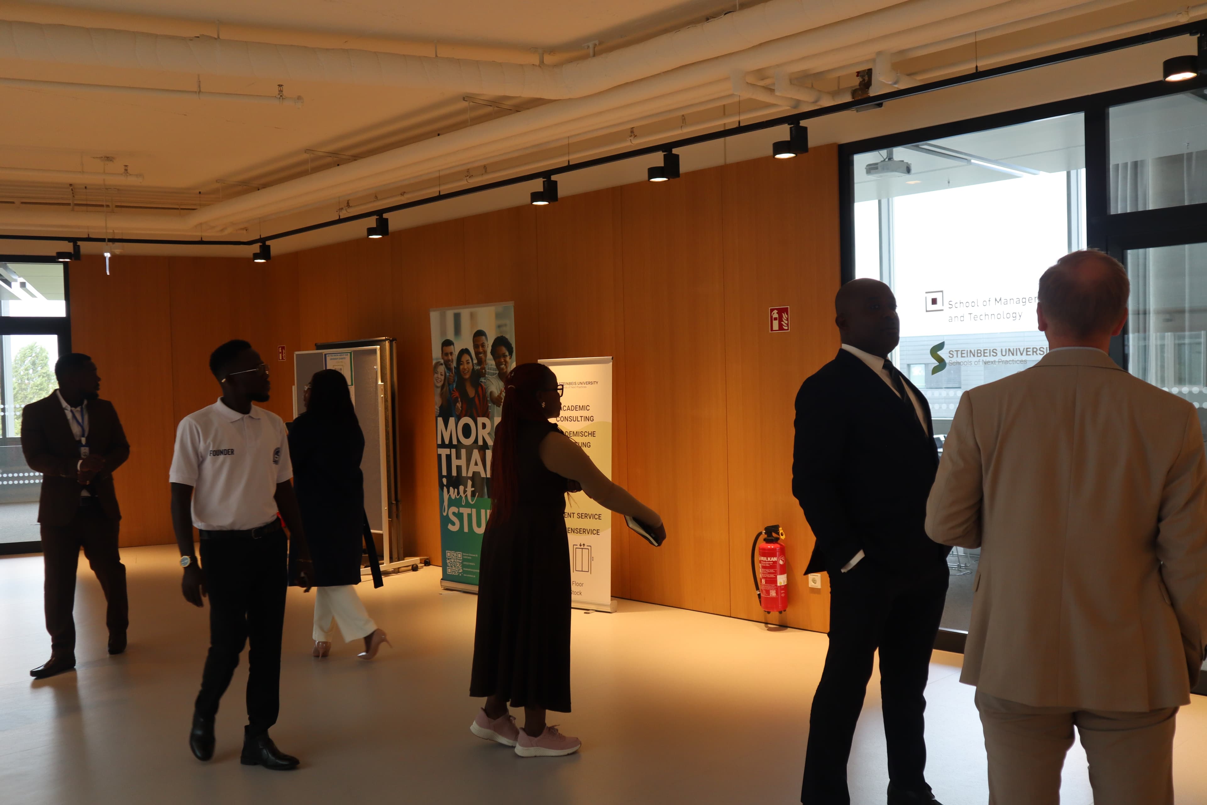 Delegation members tour an indoor exhibition space.